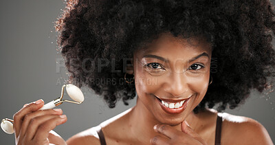 Buy stock photo Woman, beauty and quartz roller in studio for facial routine, smile and anti aging by gray background. African person, portrait and happy with massage tools, circulation or skin with results in Kenya