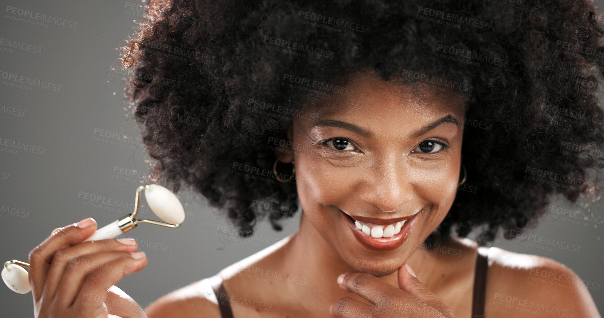 Buy stock photo Woman, beauty and quartz roller in studio for facial routine, smile and anti aging by gray background. African person, portrait and happy with massage tools, circulation or skin with results in Kenya