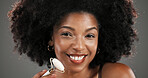Woman, jade roller and portrait in studio with facial routine, smile or anti aging by background. African person, beauty and happy for massage tools, circulation or dermatology for results in Nigeria