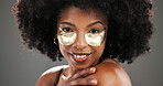Beauty, eye mask and portrait of black woman in studio for facial treatment, skincare and dark circles. Dermatology, salon and person with pads for anti aging, health and cosmetics on gray background