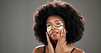 Skincare, eye mask and portrait of black woman in studio for facial treatment, beauty and dark circles. Mockup, space and person with pads for anti aging, health and cosmetics on gray background