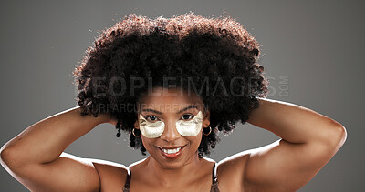 Buy stock photo Happy, eye mask and portrait of black woman in studio for facial treatment, beauty and dark circles. Dermatology, skincare and person with pads for anti aging, afro and cosmetics on gray background