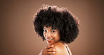 Body care, skincare and woman with portrait in studio with natural glow, hydration and collagen. Mockup space, african person and happy with beauty treatment for skin regeneration on brown background