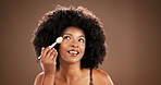 Makeup brush, happy and face of black woman in studio for cosmetics, foundation and skincare. Cosmetology, brown background and African person with tools to apply beauty products, shine and makeover