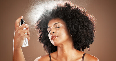Buy stock photo African woman, face mist and skincare in studio for hydration, beauty and facial treatment. Female person, afro and setting spray of makeup prep, refreshing cosmetics and makeover on brown background