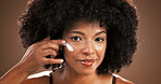 Skincare, woman and smile with face cream in studio for hydration, cosmetics or hyaluronic acid. Beauty, portrait or black person with moisturizer on brown background for anti aging treatment or glow