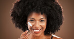 Beauty, woman and happy with face cream in studio for hydration, moisturizer and hyaluronic acid. Skincare, portrait and african person with SPF lotion on brown background for anti aging or skin glow