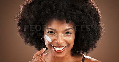 Buy stock photo Beauty, woman and happy with face cream in studio for hydration, moisturizer and hyaluronic acid. Skincare, portrait and african person with SPF lotion on brown background for anti aging or skin glow