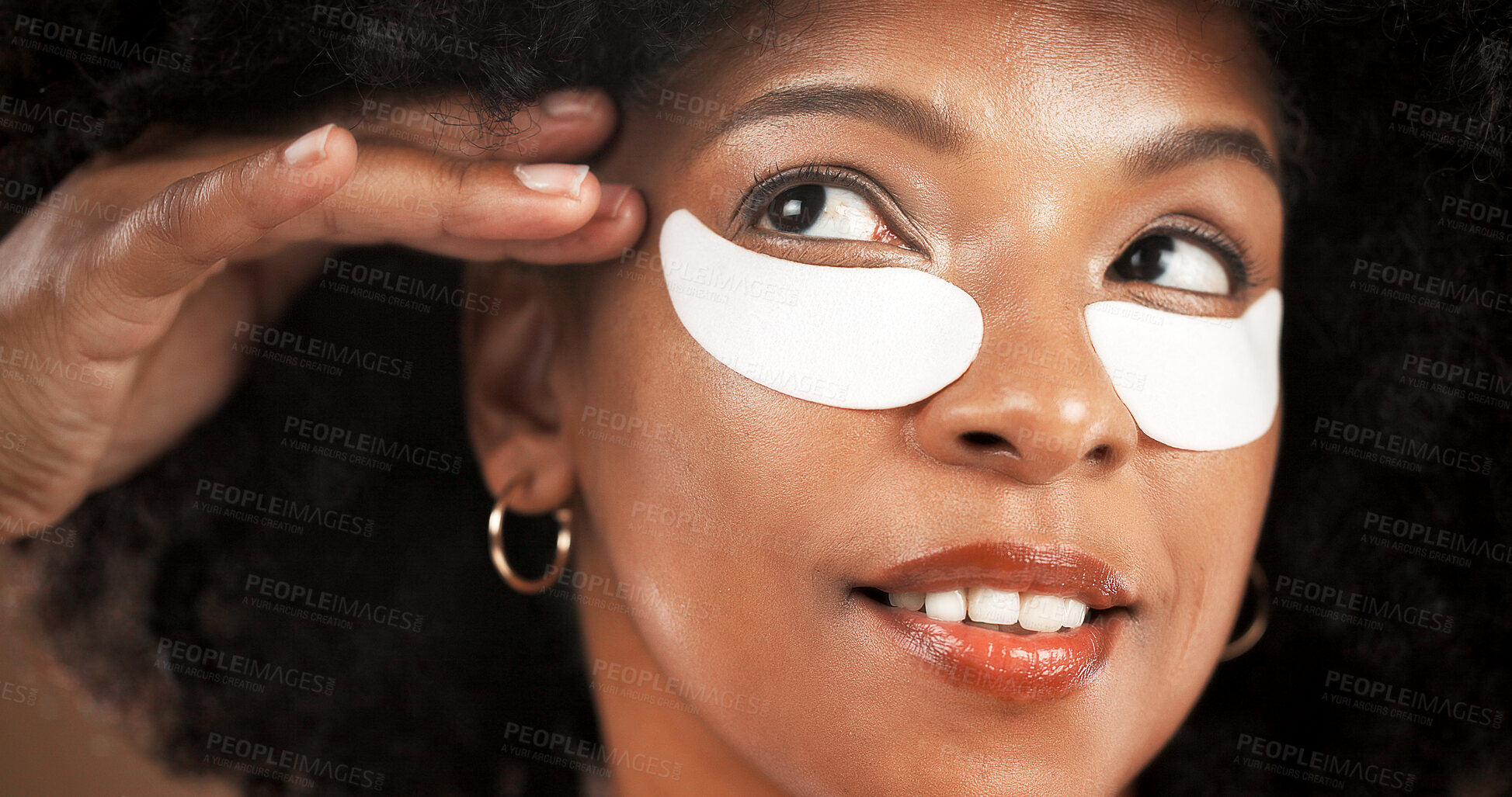 Buy stock photo Eye mask, beauty and face of black woman in studio for dark circles, hydration and wellness. Dermatology, happy and African person with pads for collagen, anti aging or facial health on background