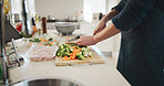 Groceries, hands and man cutting vegetables in home for cooking healthy dinner, meal or supper for diet. Knife, food and chef chopping fresh ingredients for wellness, nutrition or recipe in kitchen.