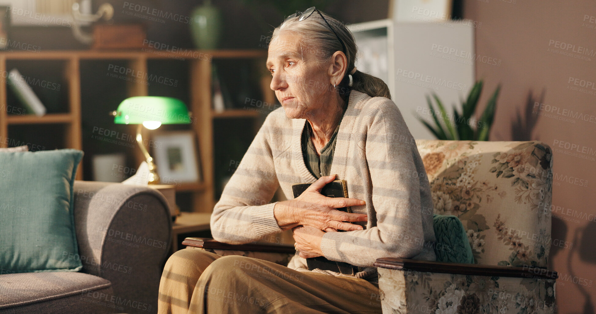 Buy stock photo Sad, old woman and thinking with picture frame on sofa for mourning, loss and lonely in retirement. Senior widower, person with depression and hug photo in home for nostalgia, memory or broken heart