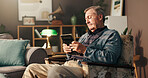 Elderly, sad man and photo frame with memory for grief or loss in mourning on chair at home. Senior, male person or thinking with picture, depression or nostalgia for missing piece or lonely house