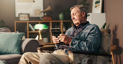 Buy stock photo Elderly, sad man and photo frame with memory for grief or loss in mourning on chair at home. Senior, male person or thinking with picture, depression or nostalgia for missing piece or lonely house
