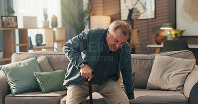 Buy stock photo Senior man, walking stick and pain by sofa for injury, steps or balance for getting up in lounge. Osteoporosis, cane and inflammation for person with disability, rehabilitation or scoliosis in home