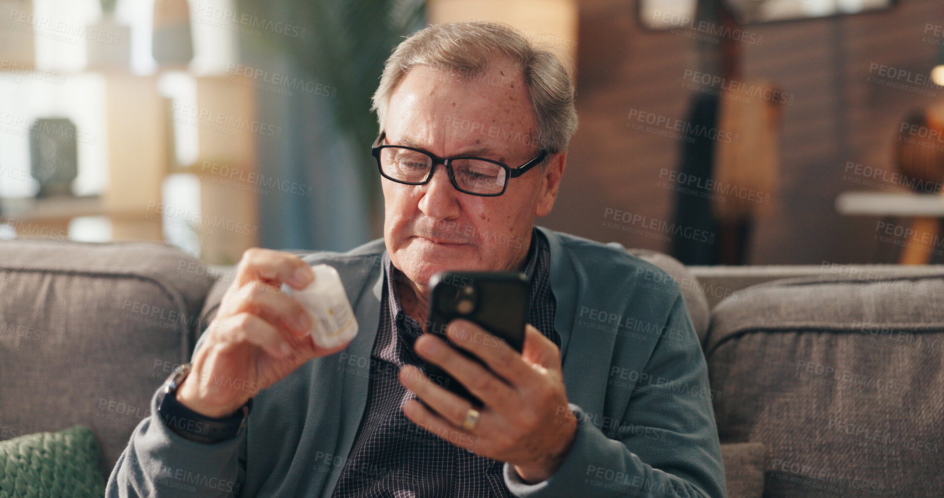 Buy stock photo Senior man, phone and reading medication on sofa for side effects or pharmaceutical instructions. Elderly, male person or patient with pills on mobile smartphone for research or prescription at home