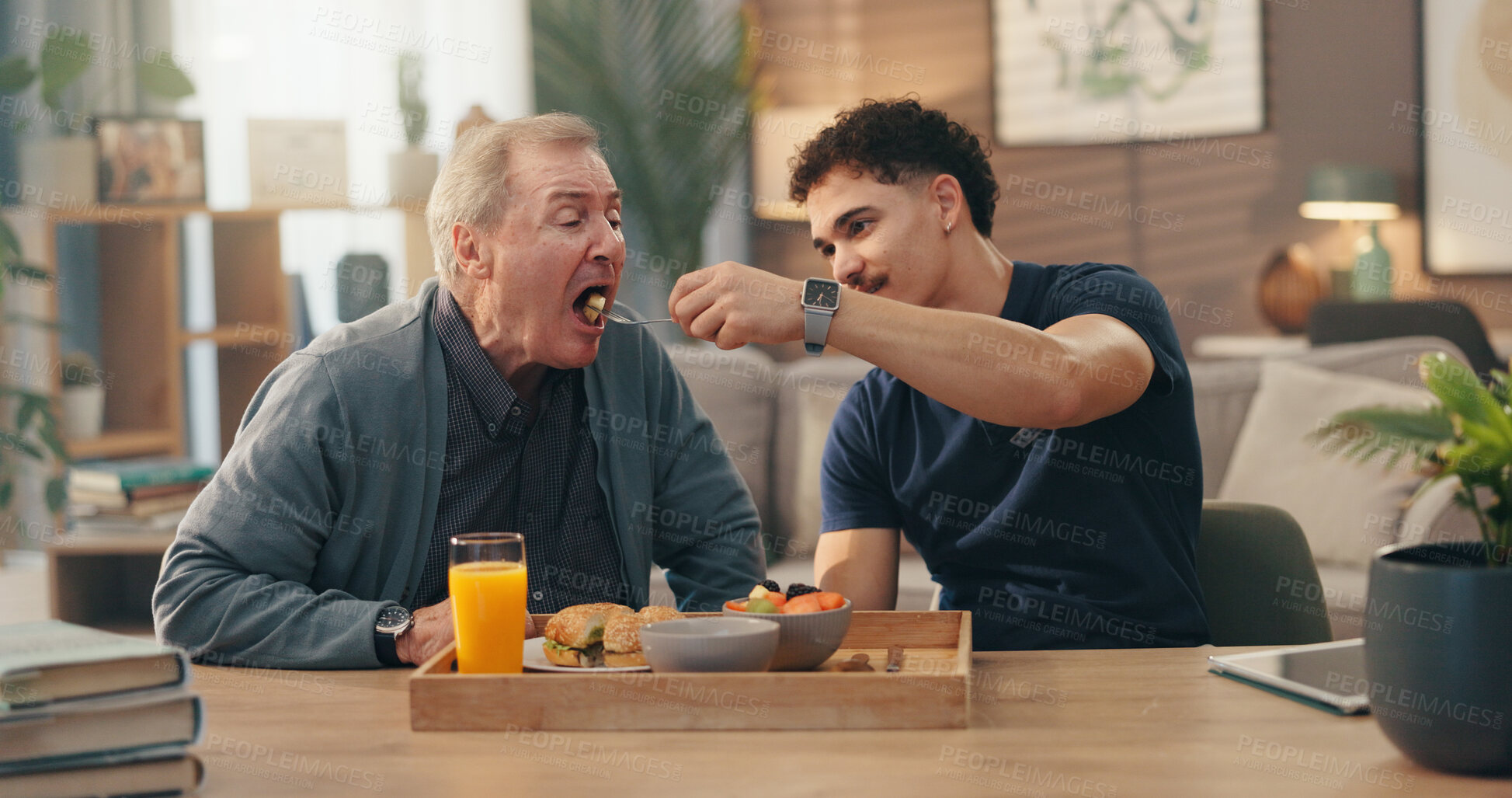 Buy stock photo Home, caregiver and feed senior man in retirement for nutrition, assistance and lunch meal. Assisted living, nurse and helping old person with eating in lounge for rehabilitation and homecare service