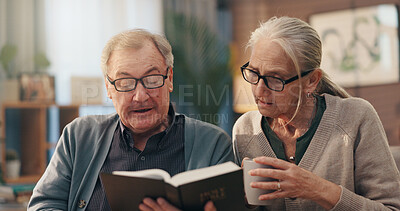 Buy stock photo Senior couple, bible and faith in home for reading, study and tea cup with spiritual scripture in lounge. Old man, woman and book for learning with Christianity, religion and coffee in retirement