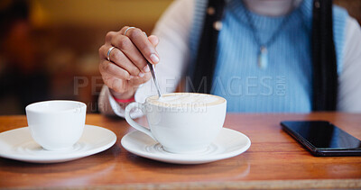 Buy stock photo Hands, cafe and customer stirring coffee on table for beverage, espresso and drink preparation. Cup, latte and woman with spoon for mixing morning cappuccino with fresh cream in restaurant to relax