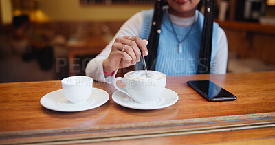 Buy stock photo Hands, drink and customer stir coffee on table for beverage, espresso and preparation. Cup, latte and woman with spoon for mixing morning cappuccino with fresh cream or foam in restaurant to relax