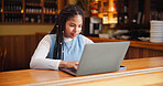 Student, coffee shop and woman on laptop for learning, online education and assignment in cafe. Restaurant, reading and person on computer for research, school project and university assessment