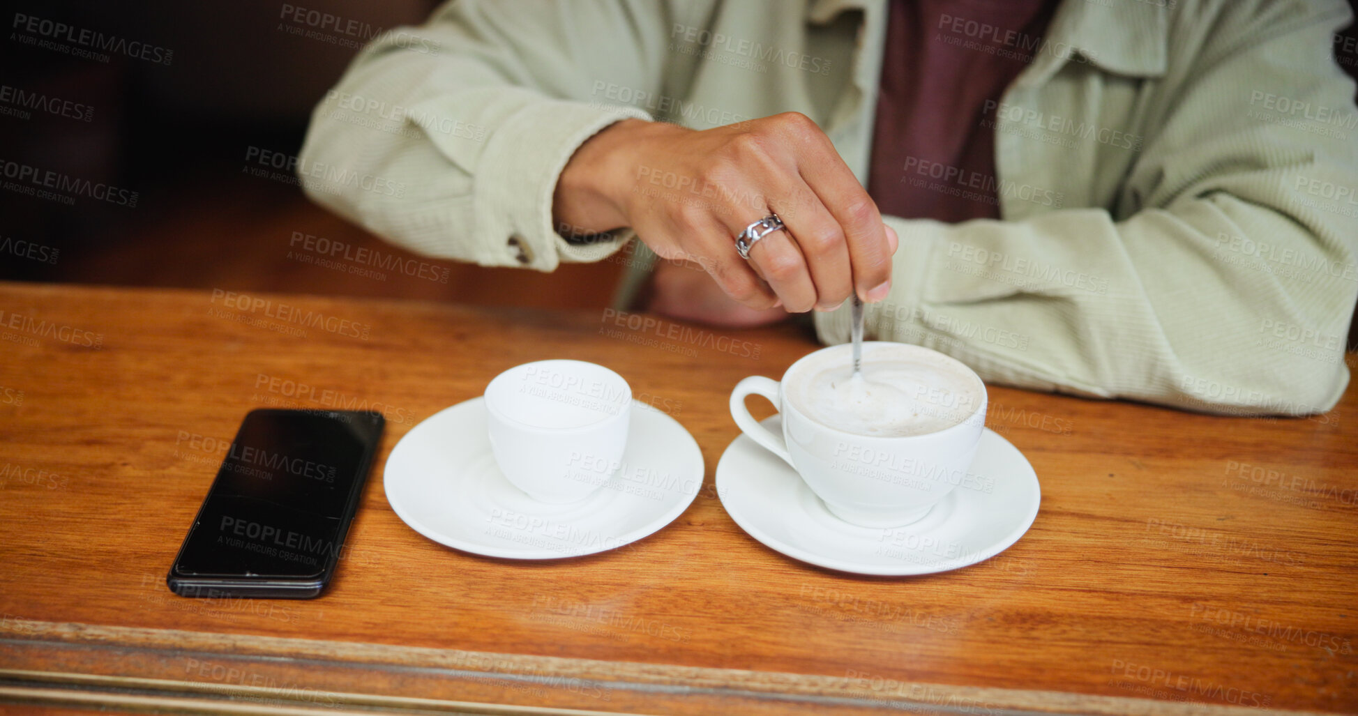 Buy stock photo Hands, cafe and man stir coffee on table for beverage, espresso and customer with drink preparation. Cup, morning latte and person with spoon to mix foam with fresh cream in restaurant to relax