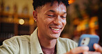 Man, smartphone and texting with smile at cafe with contact, typing and streaming on web at restaurant. Person, phone and laugh with meme, search and check post with social media at coffee shop