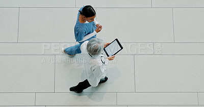 Buy stock photo Women, doctor and medical team with tablet above for healthcare research or discovery at hospital. Top view, female people or nurse walking with technology or app for health development on space