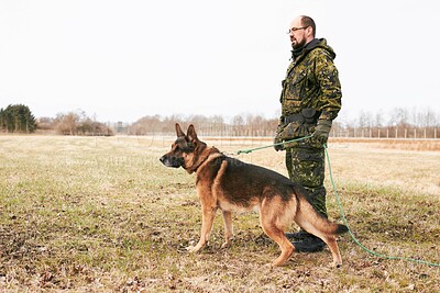 Buy stock photo Male officer, military uniform and german shepherd on leash or dog guarding territory and outdoors. Soldier, pet with rope and in the field for army training or drills or man official in gear outside
