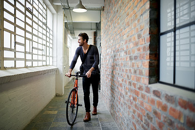Buy stock photo Man, bicycle and smile in hallway on travel by window, thinking or ready for ride at office building. Person, happy and bike in corridor for sustainability with eco friendly transportation on commute