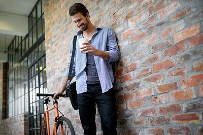 Buy stock photo Coffee, bicycle and happy man in startup for creative career, job commute and opportunity ideas. Smile, morning beverage or designer thinking of bike, carbon footprint and travel in hallway in office