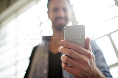 Buy stock photo Below, hand and phone with man in office as app user for communication, download or update. Internet, search and social media with employee closeup in workplace for mobile browsing or connection