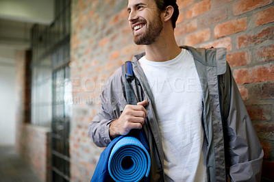 Buy stock photo Fitness, gym bag and man in hallway, smile and relax with wellness, decision and training. Happy person, athlete and yoga mat in lobby, workout and cheerful with joy, weekend break and healthy