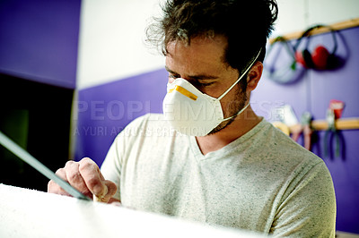 Buy stock photo Manufacturing, man and sanding surfboard in workshop for production process, design or creative craftsmanship. Surfer, blank or person with tools for shape, polish or smooth foam with protective mask