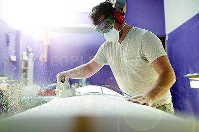 Buy stock photo Man, tool and sanding surfboard in workshop for grinding process, shape surface and custom design. Male person, equipment and prepare for product production, polish texture and remodeling maintenance