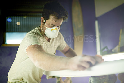 Buy stock photo Craft, surfboard and polish with man in workshop for manufacturing, sports equipment and craftsman. Entrepreneur, maintenance and repair with person and mask for small business and quality assurance