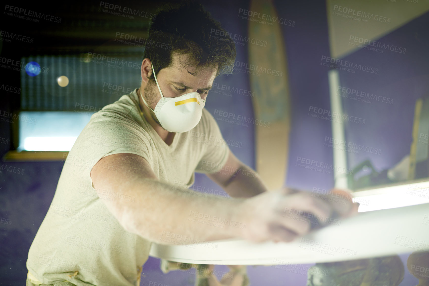 Buy stock photo Craft, surfboard and polish with man in workshop for manufacturing, sports equipment and craftsman. Entrepreneur, maintenance and repair with person and mask for small business and quality assurance