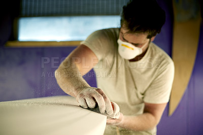 Buy stock photo Hands, sanding and surfboard with man in workshop for fixing, maintenance or repair. Design, production and sandpaper with person in small business or surf shop studio for manufacturing process