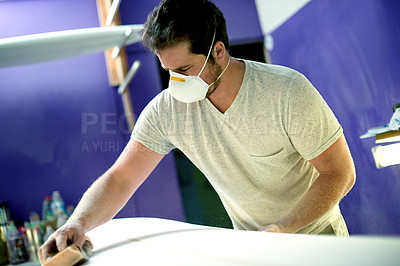 Buy stock photo Mask, sanding and surfboard with man in workshop for maintenance or repair of surf equipment. Production, process and sandpaper with person in studio for manufacturing or small business startup