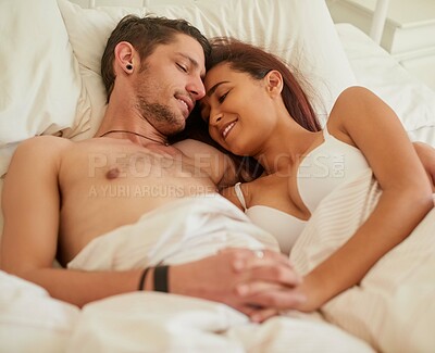 Buy stock photo Couple, smile and holding hands in bed for hug, romance and love in bedroom. Man, woman and happy at home for cuddle, security and relaxation in morning about to sleep for together in marriage