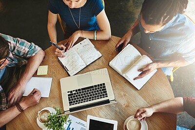 Buy stock photo High angle shot of a group of students studying in a coffee shop