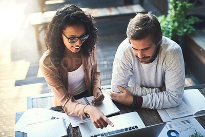 Buy stock photo Shot of two designers having a meeting at a coffee shop