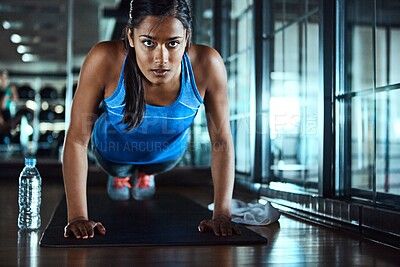 Buy stock photo Serious, push up and woman in gym for workout with strength, wellness and arms training. Fitness, health and female athlete with exercise, challenge with strong muscle and power in sports center.