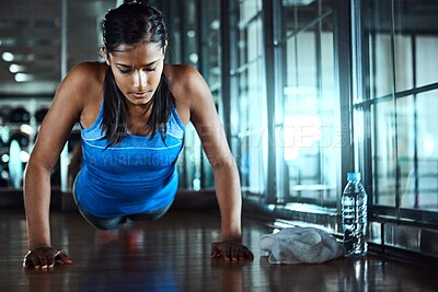 Buy stock photo Workout, push up and woman in gym for strength, wellness and arms training for fitness. Serious, health and female athlete with exercise for body goals for muscles and power in sports center.