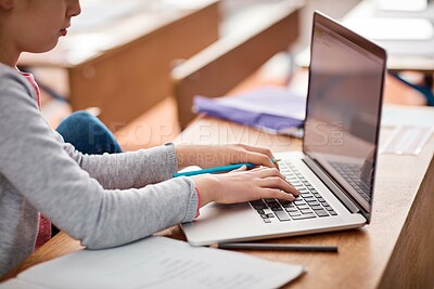 Buy stock photo Laptop, typing and girl in kids classroom for research project with growth, child development and digital education. Website, elearning and school student with online course for exam notes at desk