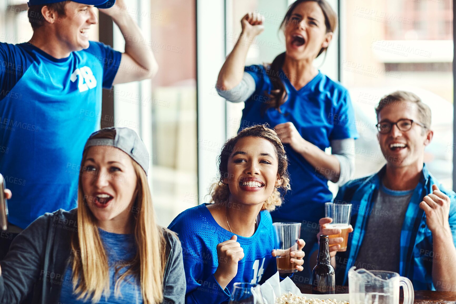 Buy stock photo Sports, fans and success with drinks for celebration, support and people watching tv team game in restaurant. Friends, cheering and live broadcast with happiness, excited and alcohol for baseball win