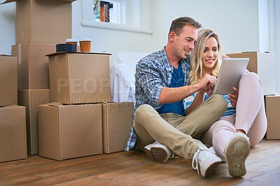 Buy stock photo New home, box and couple with tablet for moving, mortgage purchase and house investment. Homeowner, real estate and man and woman on digital tech for interior design, planning and decor website