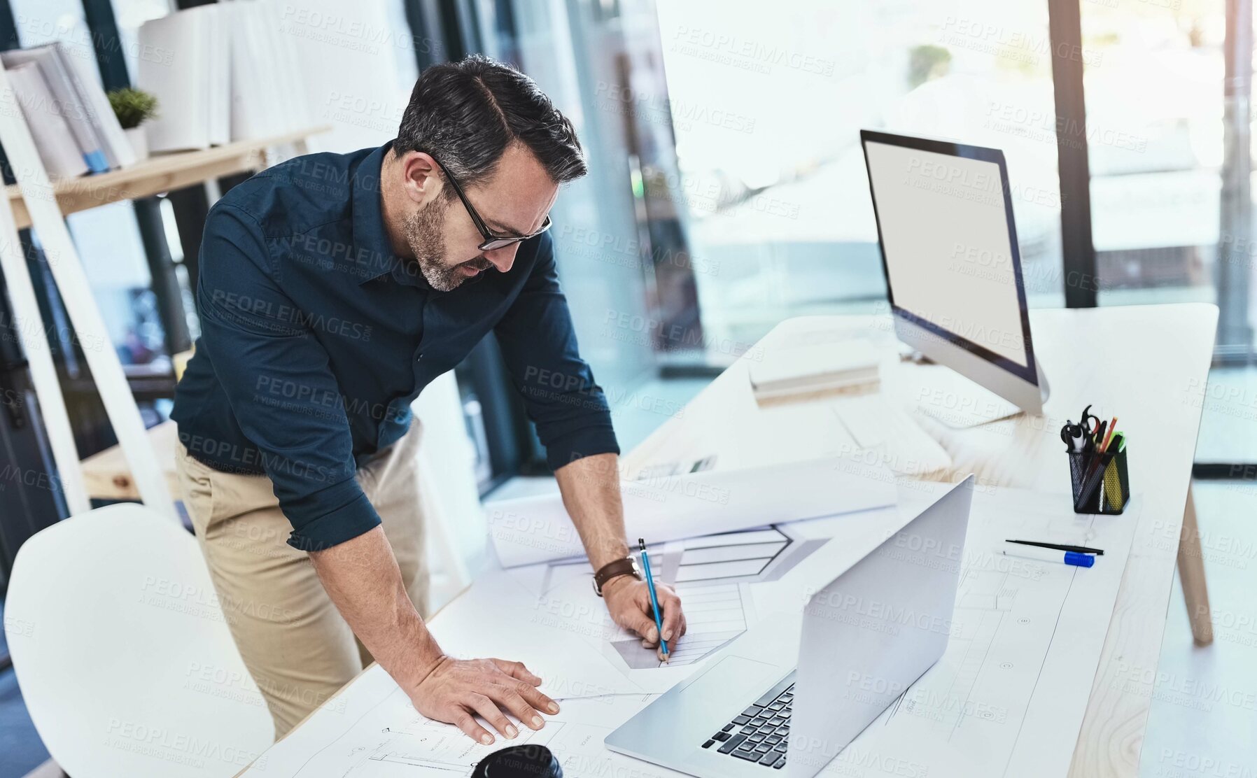 Buy stock photo Shot of a mature male architect using his laptop