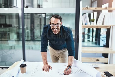 Buy stock photo Shot of a mature male architect working on a design in his office