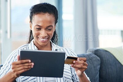Buy stock photo African, tablet and happy woman with credit card on sofa for transaction, e commerce or online shopping in living room. Payment, app and person for purchase, subscription or internet banking in home