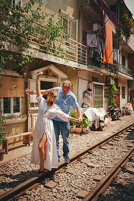 Buy stock photo Happy couple, play and railway in city for vacation, bonding together and honeymoon. Woman, man and travel on train track in town for holiday destination, adventure or outdoor with romance in Vietnam
